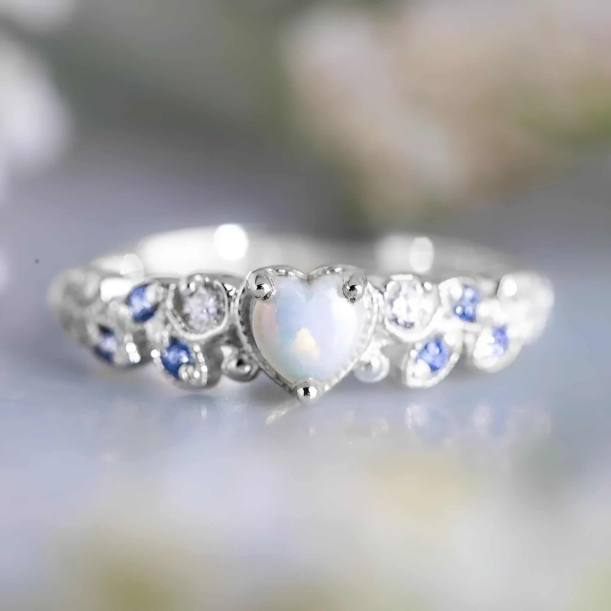 White gold tone women's heart-shaped ring with floral and oceanic pattern detailing