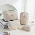 Four cube-style flannelette makeup bags in matching colour set on white background
