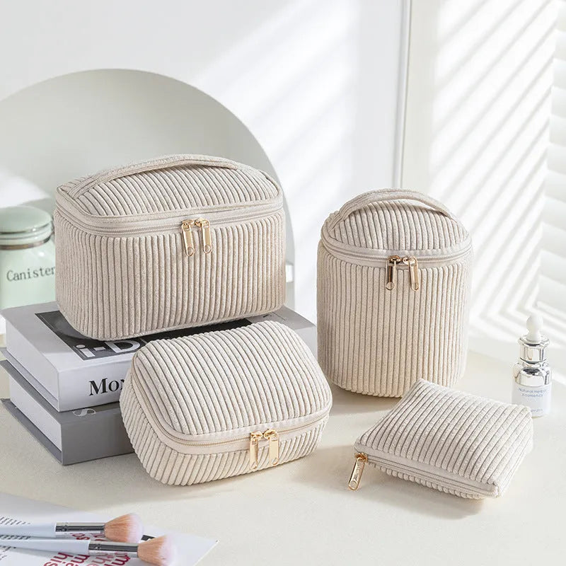 Four cube-style flannelette makeup bags in matching colour set on white background