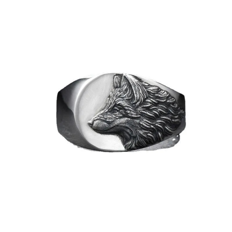 Geometric silver alloy wolf head signet ring for men on a grey background.