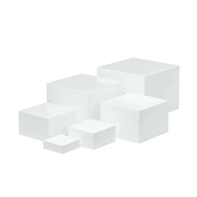 White plastic suit cube dessert display stand with six individual cubes for wedding cakes and pastries.