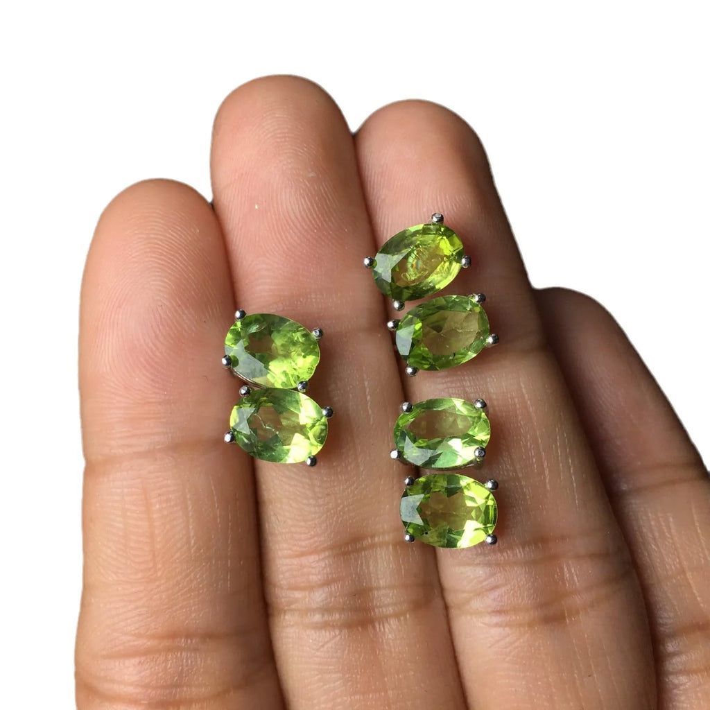 Close-up of natural grass green olivine stud earrings in S925 sterling silver settings.