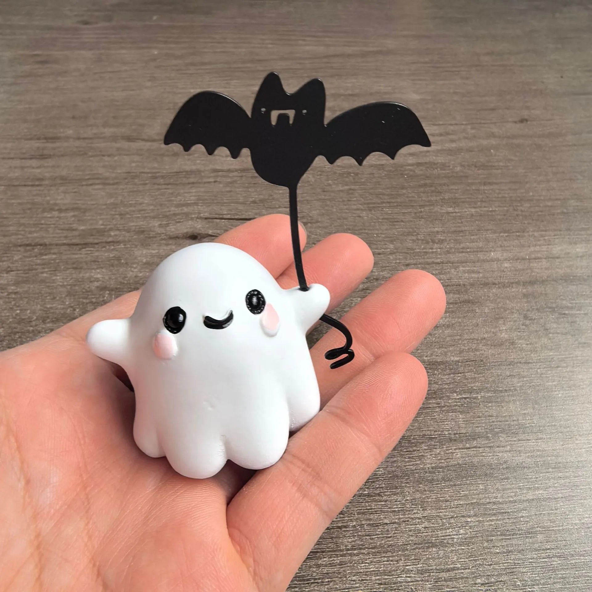 Mini resin figurine of a ghost walking a small dog, a 4x5x4cm Halloween decoration.