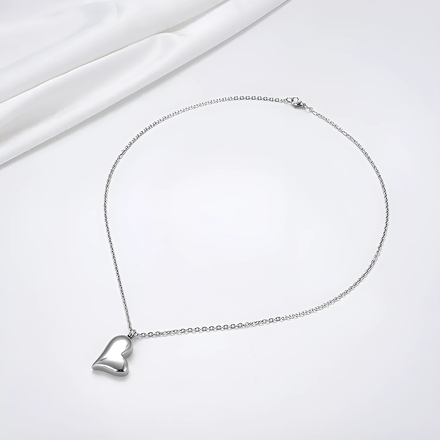 Silver tone curved peach heart stainless steel pendant necklace with adjustable chain