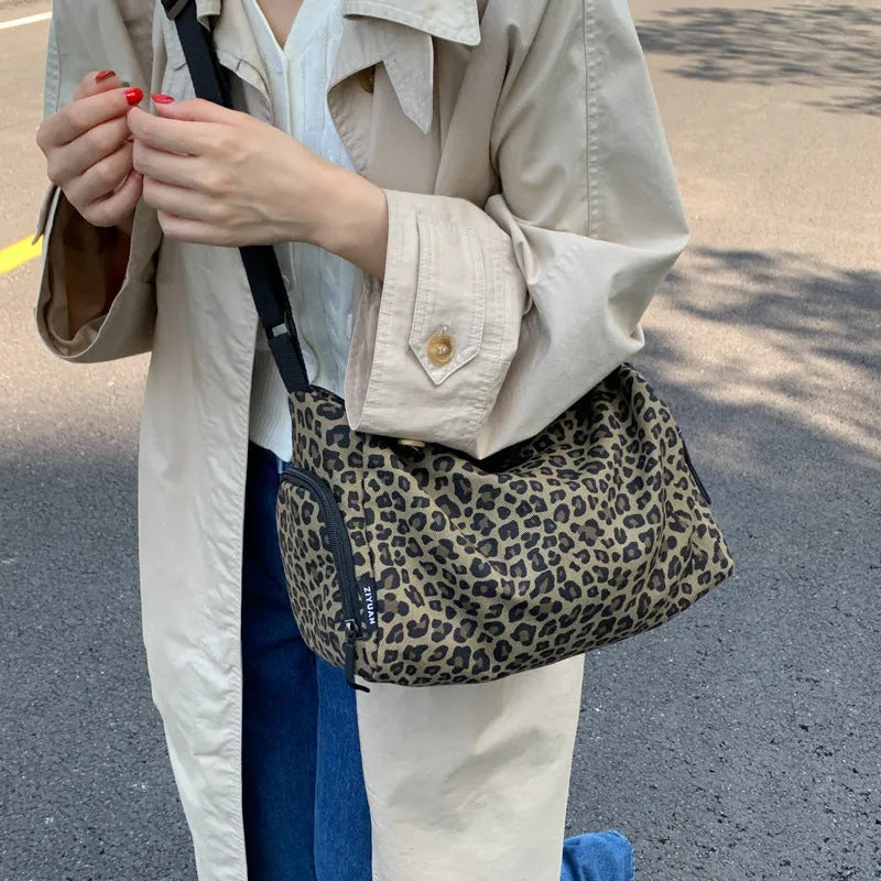Leopard print sports style cross-body messenger bag with large capacity and cloth construction