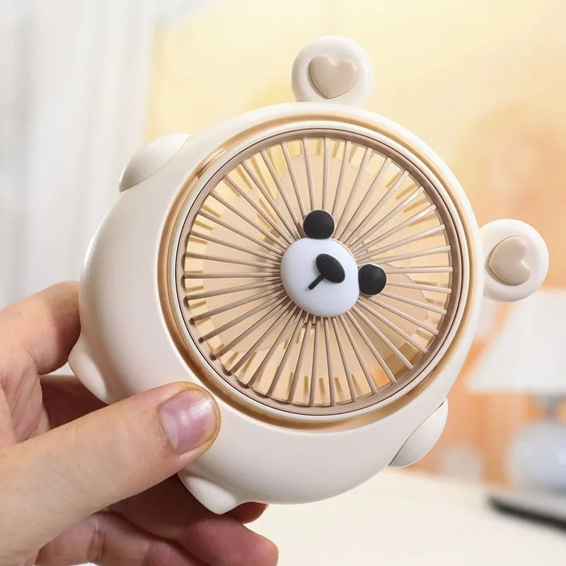 Cute puppy-themed USB desktop electric fan in various colours on a desk.