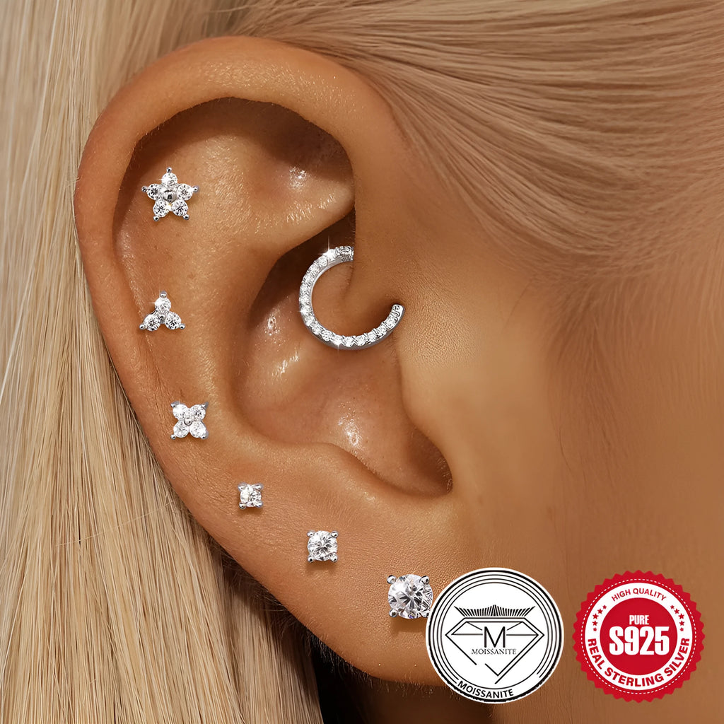 S925 sterling silver stud earrings showing petal, geometric, and round diamond designs on a grey background.