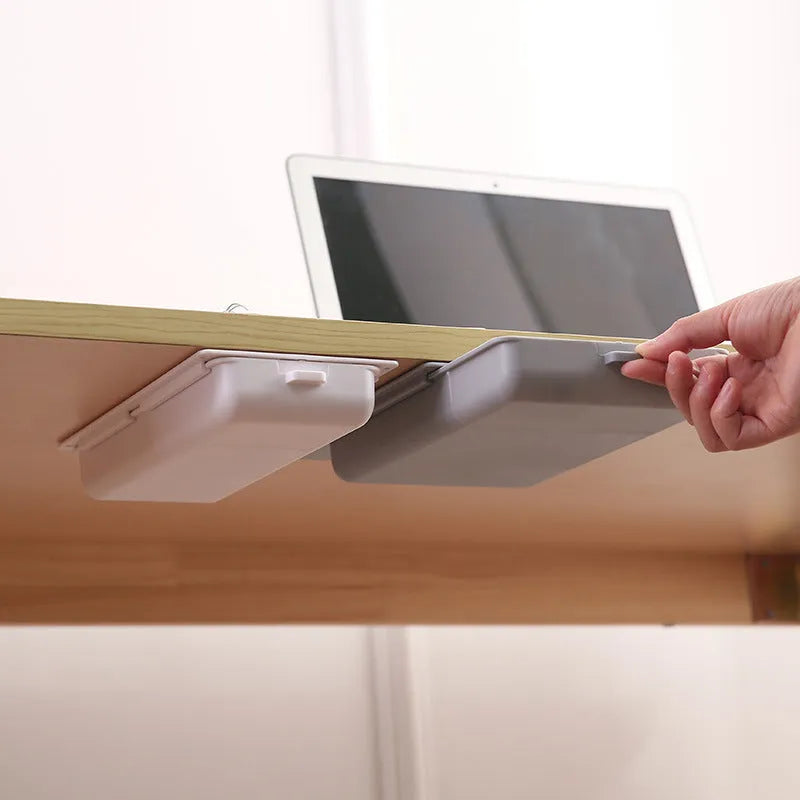 Plastic under-desk storage drawer with cover showing internal grid compartments