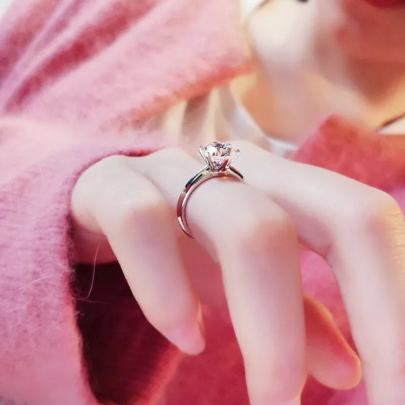White gold plated zircon ring with six-claw setting and geometric design shown on finger