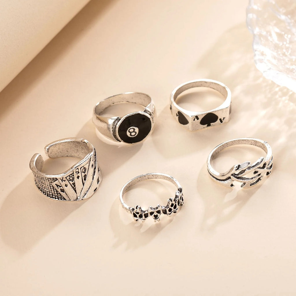 Black alloy adjustable ring with a raised retro spade playing card design on a model's hand.