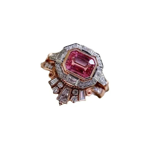 Rose gold coloured geometric women's alloy ring with a ruby detail on a white background.