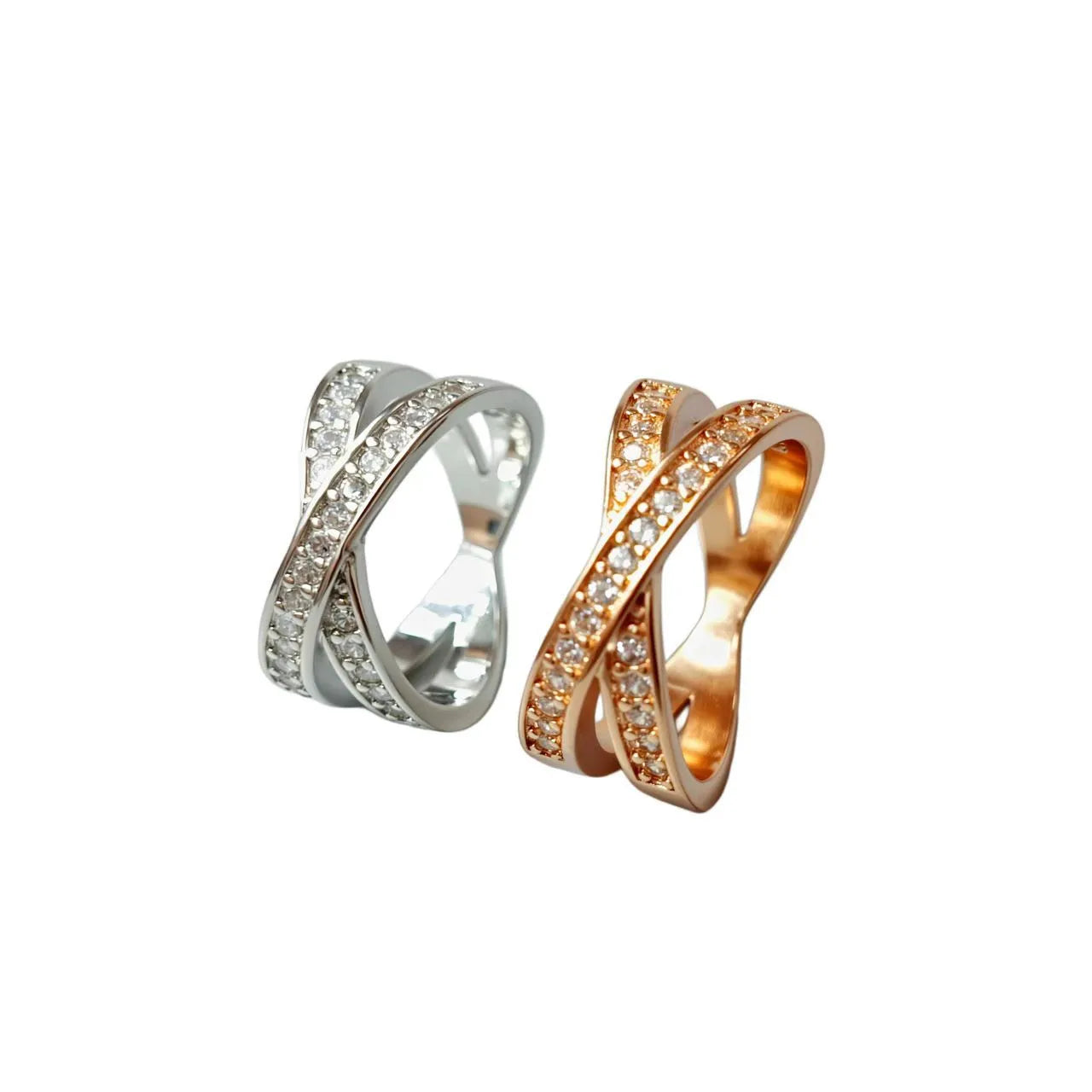 Simple metal cross ring with micro-inlaid zircon detail in silver or rose gold on a finger.