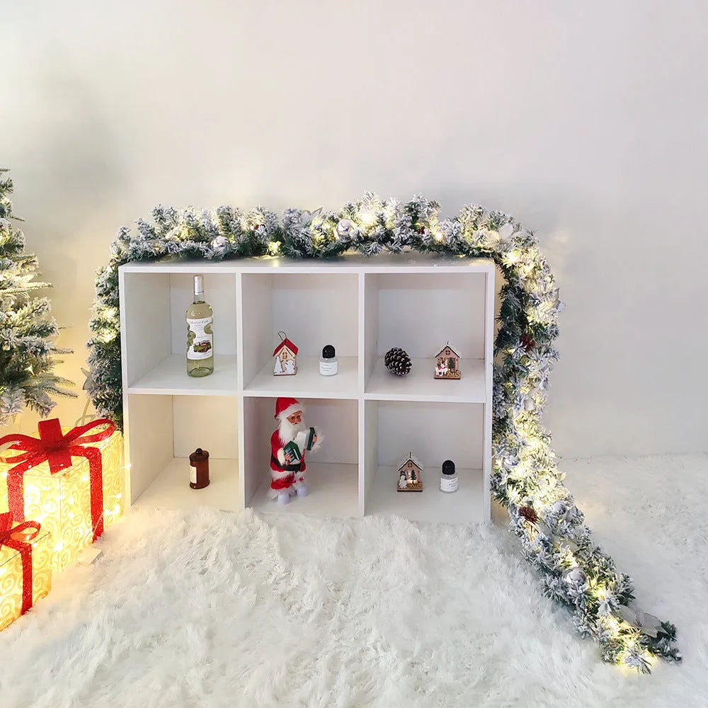 Flocked PVC rattan vine Christmas garland decoration in a festive colour, draped over a mantelpiece.