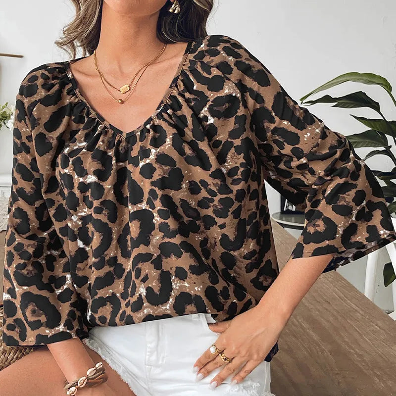 Women's multicolor leopard print V-neck polyester pullover top with half sleeves.