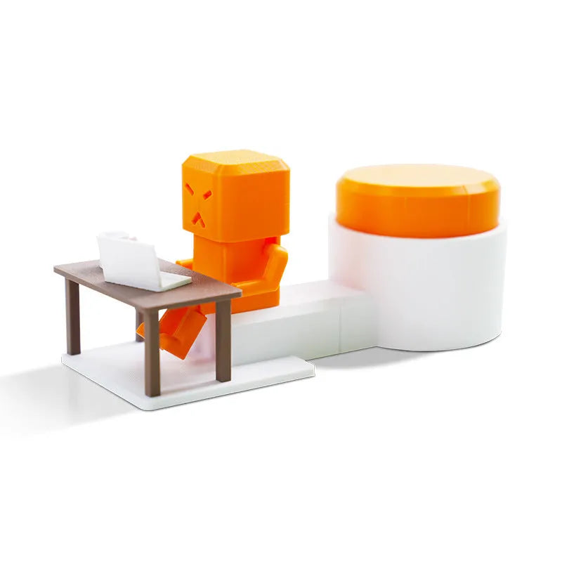 Orange plastic table-turning decompression toy on a desk.
