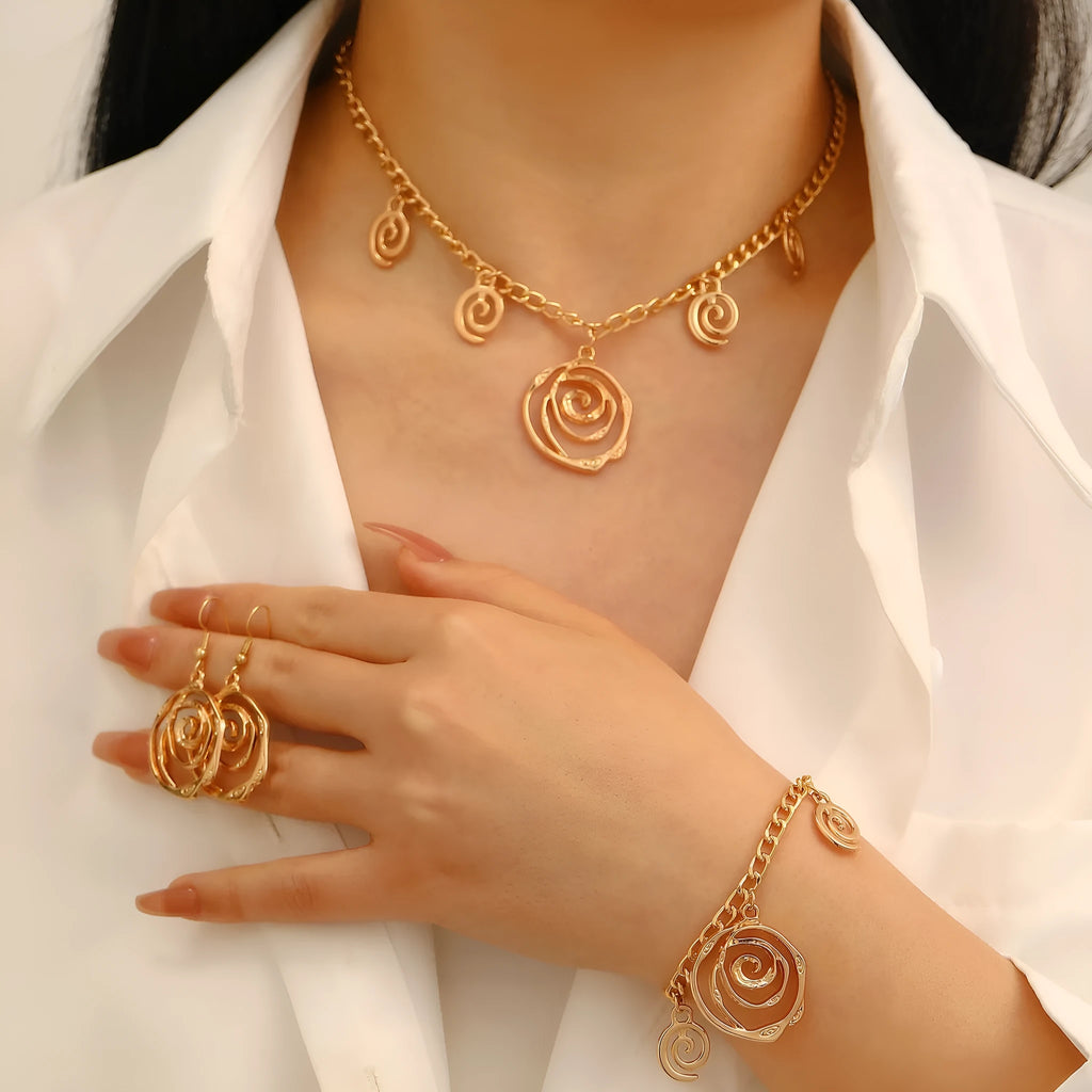 Spiral donut jewellery set with necklace, bracelet and ear hooks in gold or silver tone