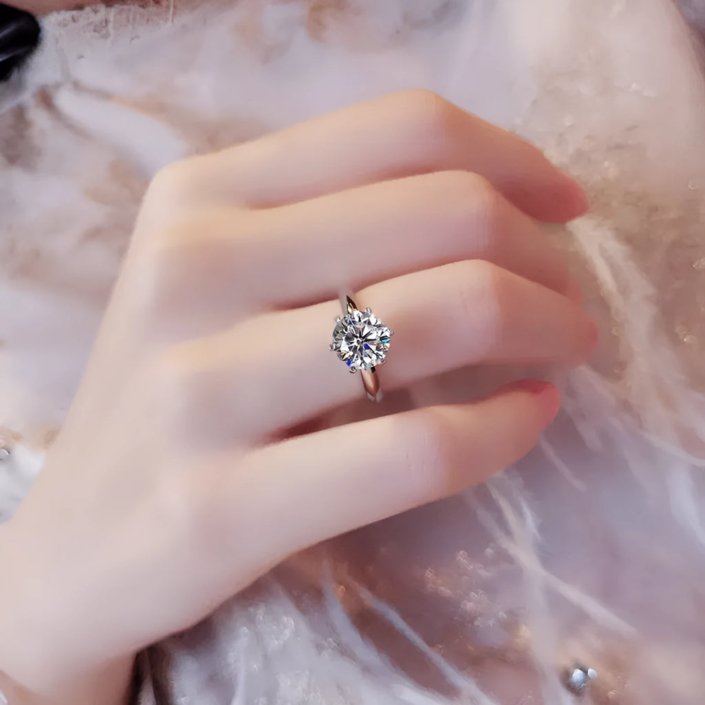 White gold plated zircon ring with six-claw setting and geometric design shown on finger