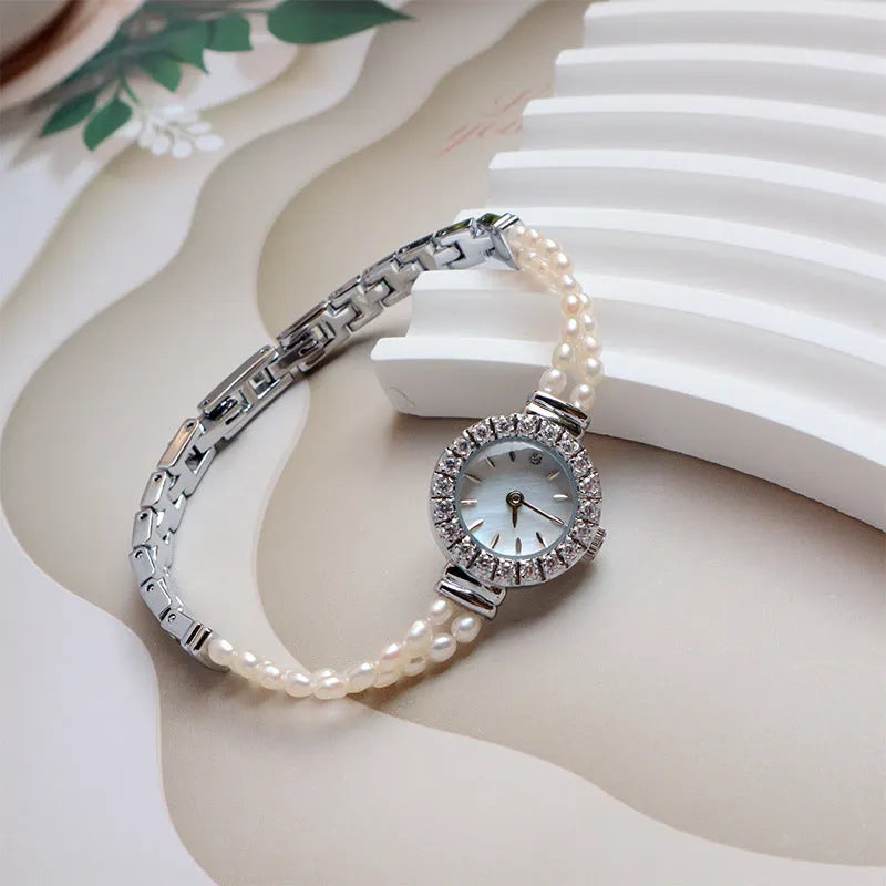Women's light gold bracelet watch with freshwater pearls and round mineral glass dial