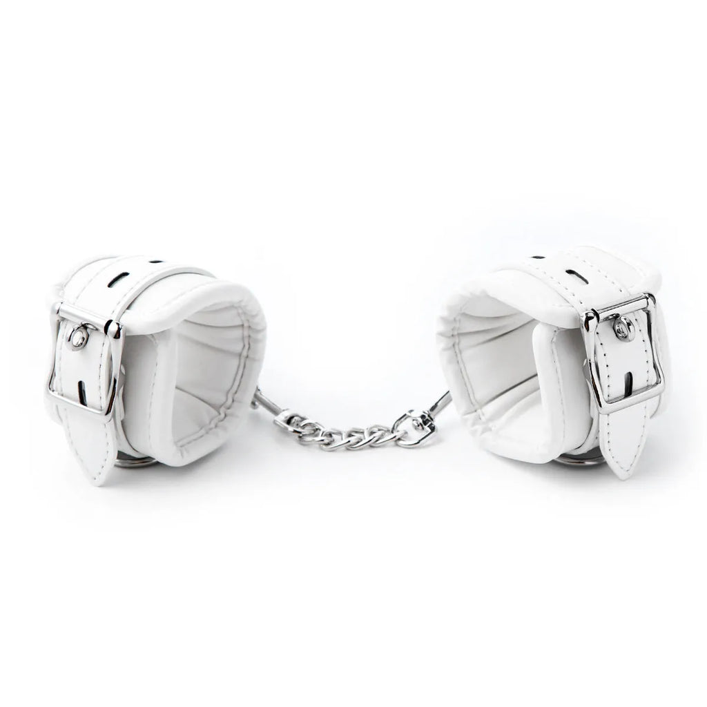 White PU sponge bondage restraint set showing handcuffs, foot cuffs and neck scarf for discipline play