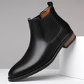 Men's black pointed toe Chelsea boots with a mid-calf height and rubber sole.