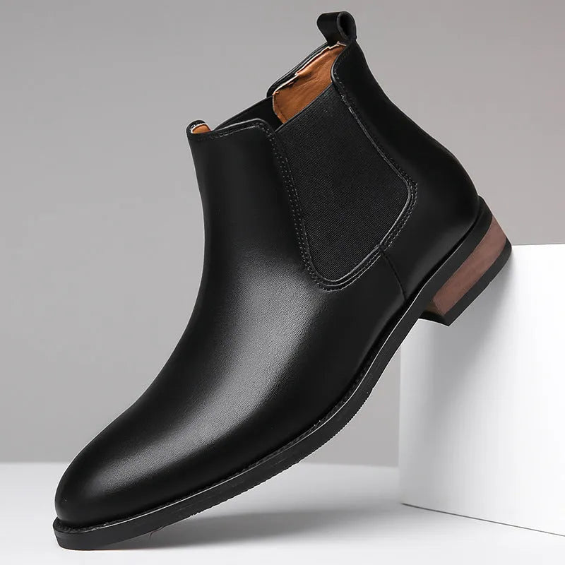 Men's black pointed toe Chelsea boots with a mid-calf height and rubber sole.