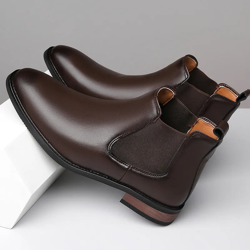 Men's black pointed toe Chelsea boots with a mid-calf height and rubber sole.