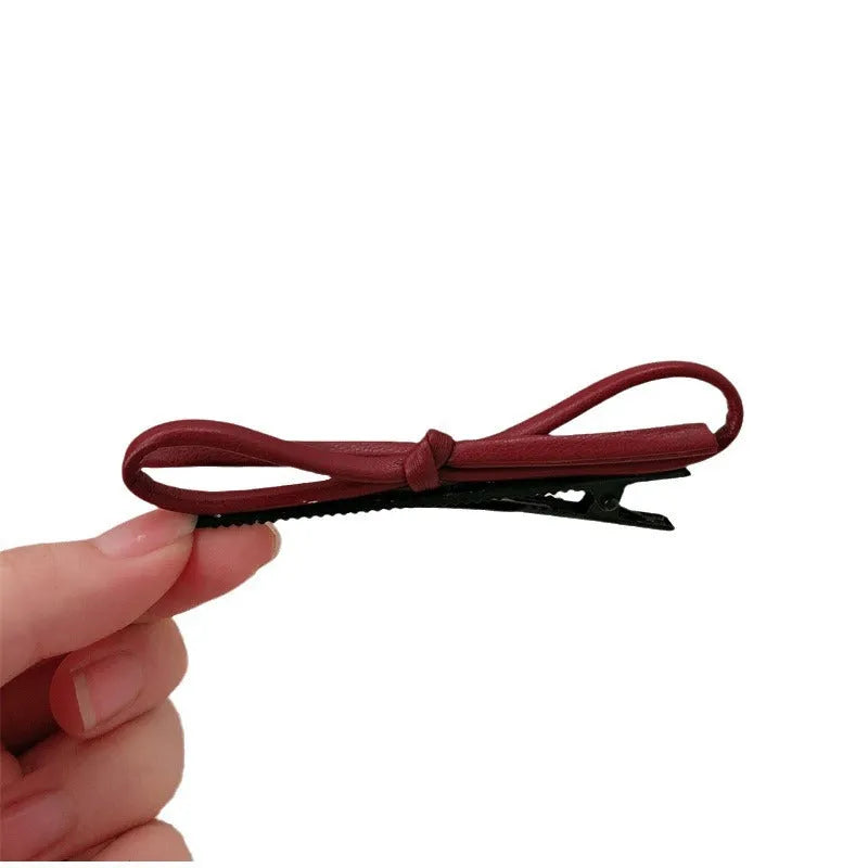 Wine red leather bow barrette hair clip with adjustable metal grip mechanism