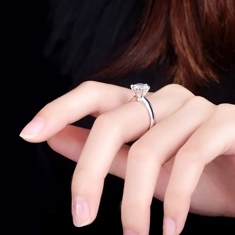 White gold plated zircon ring with six-claw setting and geometric design shown on finger
