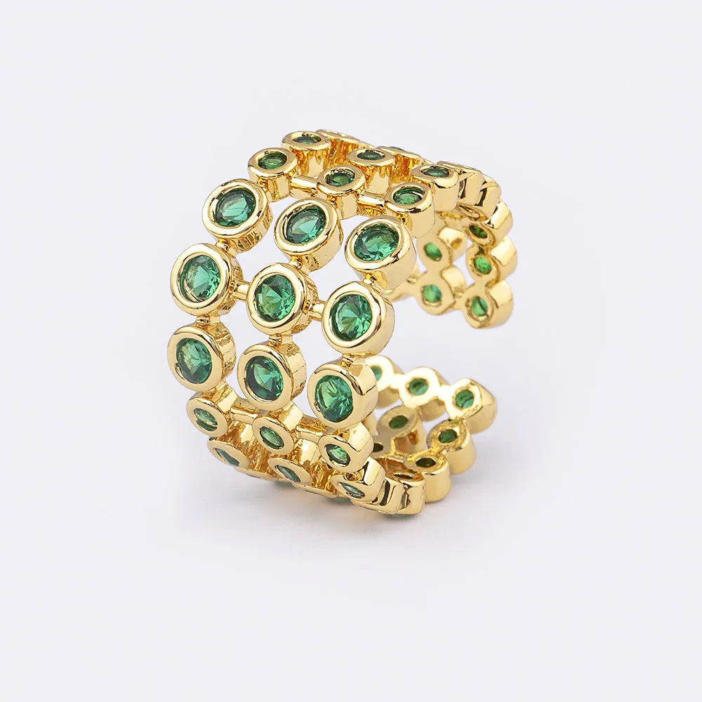 Gold-coloured exaggerated wide band ring with three-layer design and full green zircon stone setting.