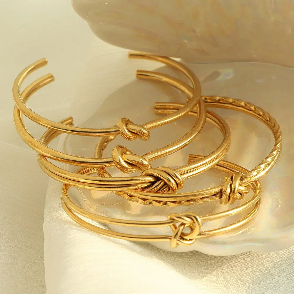 Women's adjustable stainless steel bracelet with knotted C-shaped design and 18K gold plating