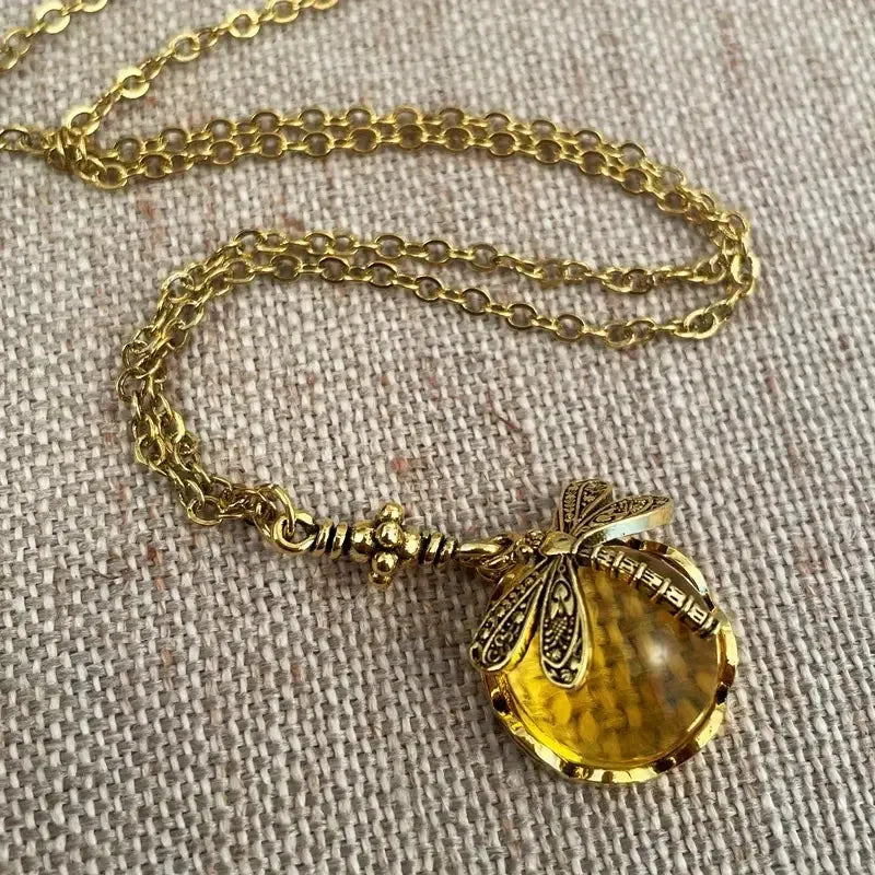 Yellow vintage bronze dragonfly pendant necklace on adjustable silver chain