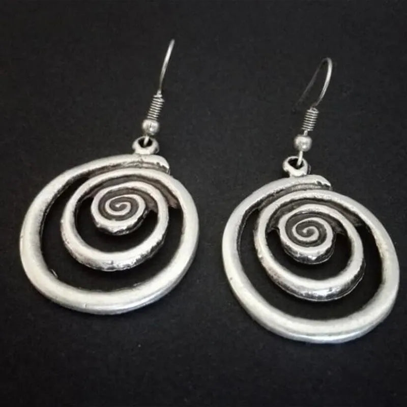 Silver geometric spiral earrings with distressed texture, measuring 2.6cm by 5cm