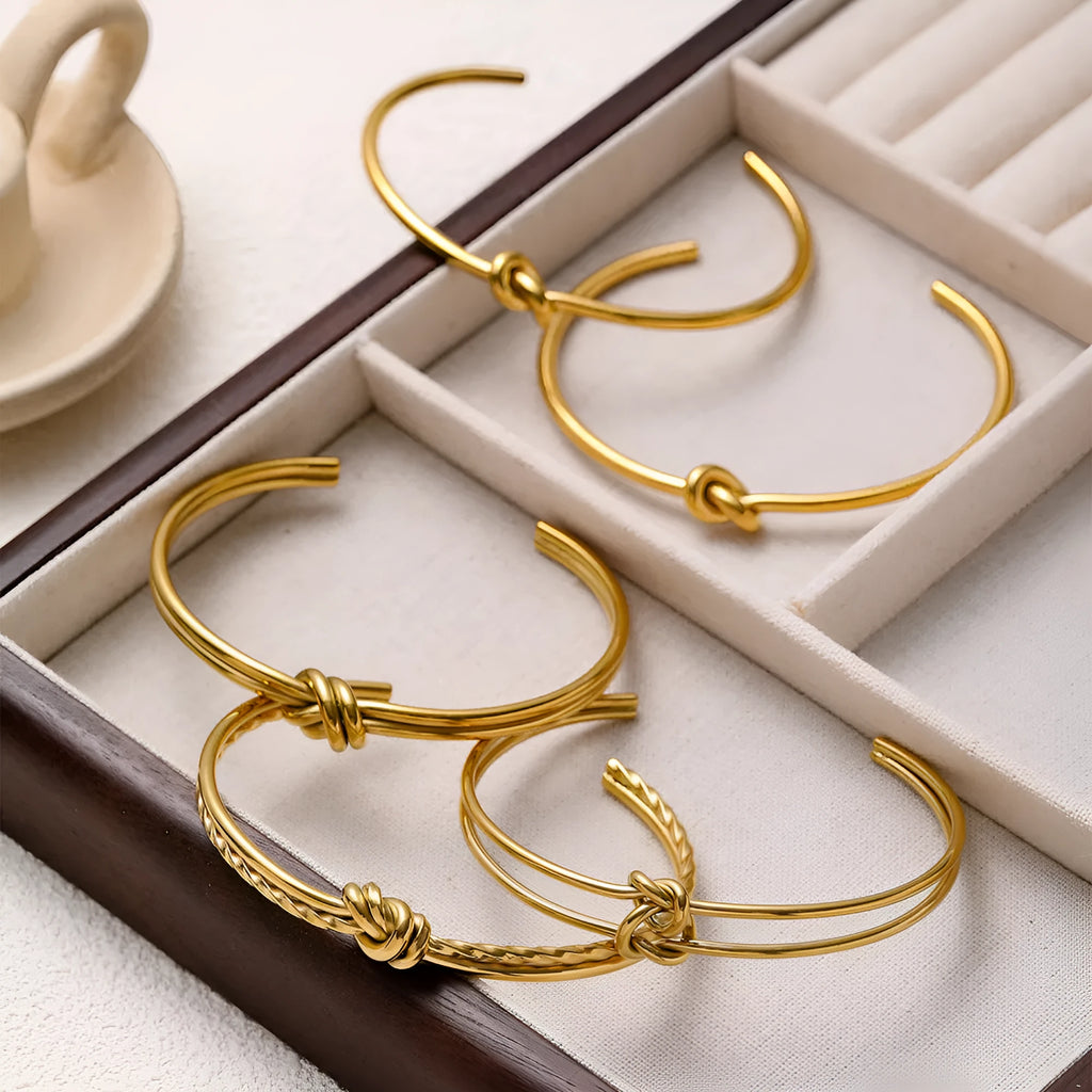 Women's adjustable stainless steel bracelet with knotted C-shaped design and 18K gold plating