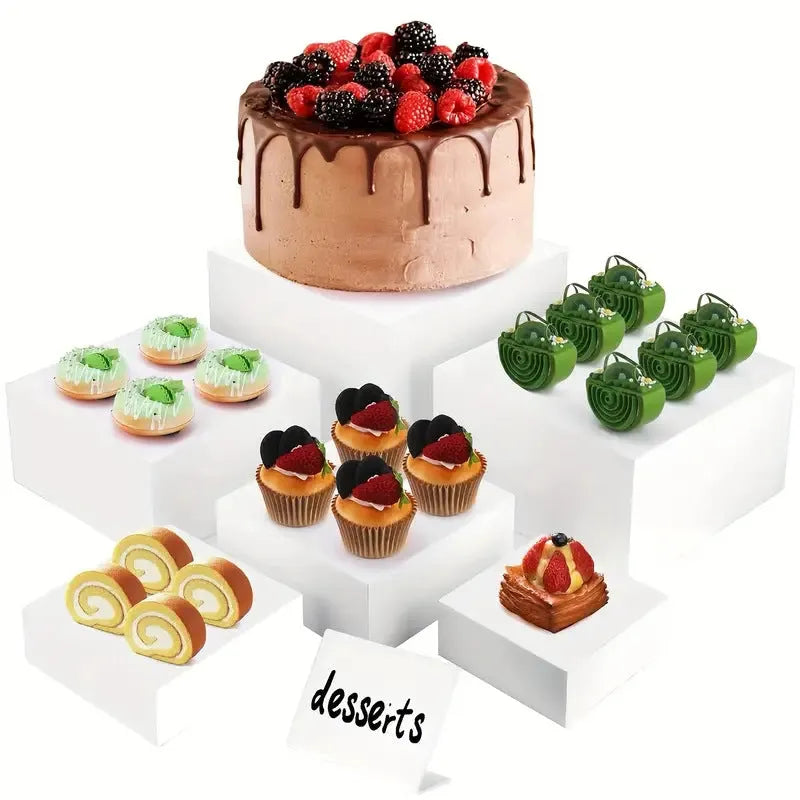 White plastic suit cube dessert display stand with six individual cubes for wedding cakes and pastries.