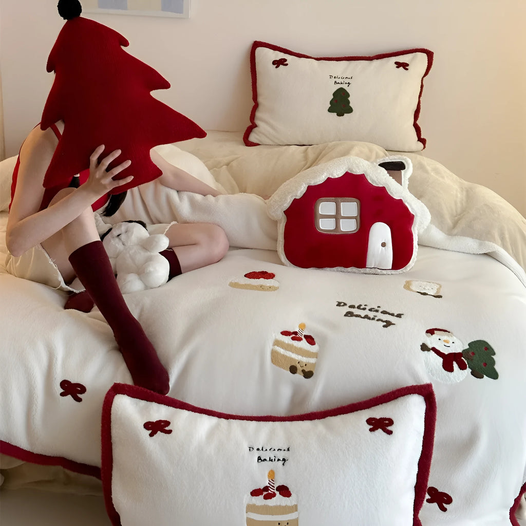 Snowman Milk Pastry cartoon print bedding four-piece set including sheet, duvet cover, and pillowcases on a bed.