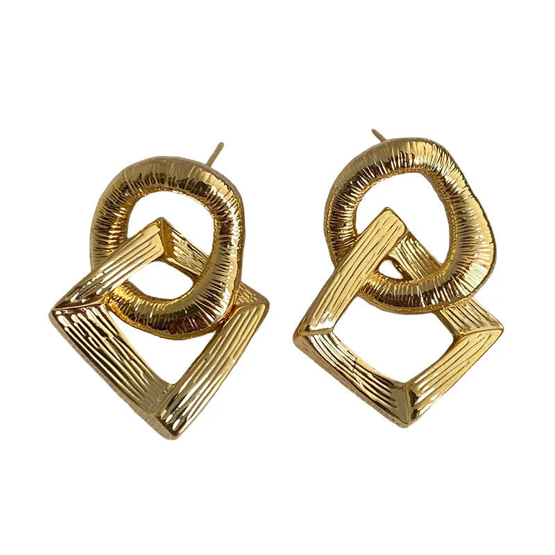 Retro style geometric circle pendant earrings in gold or silver colour with a 3.4cm drop length.