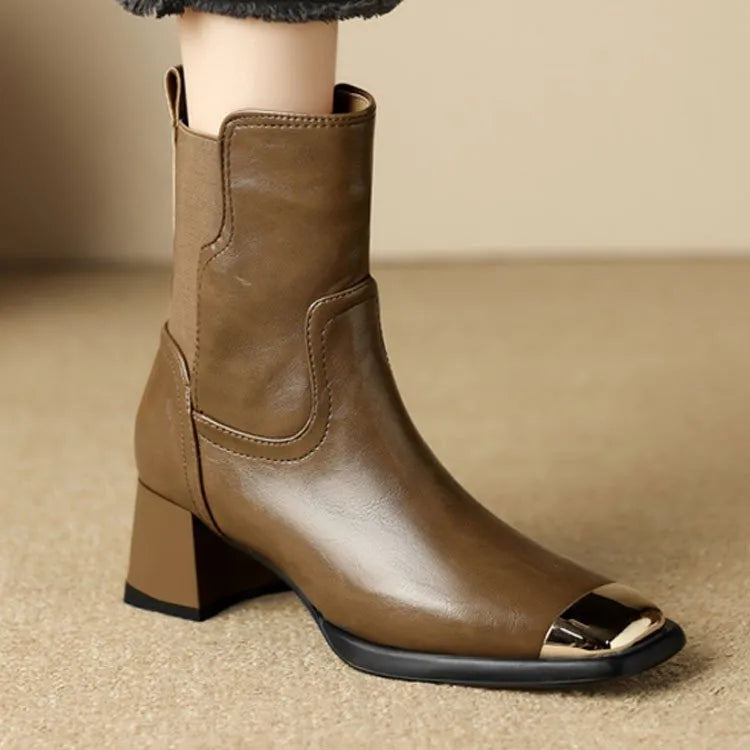 Women's brown and black slimming Martin ankle boots with side zipper and decorative metal details.