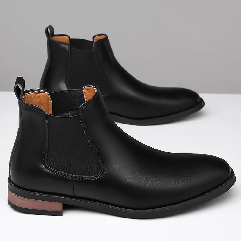 Men's black pointed toe Chelsea boots with a mid-calf height and rubber sole.