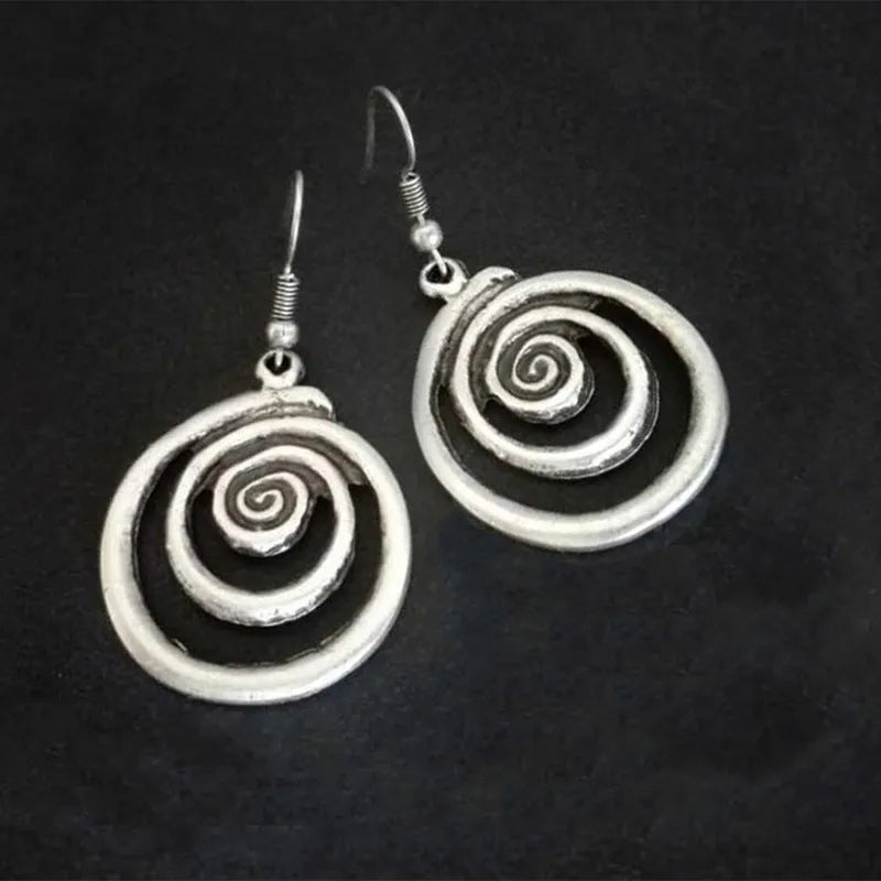 Silver geometric spiral earrings with distressed texture, measuring 2.6cm by 5cm