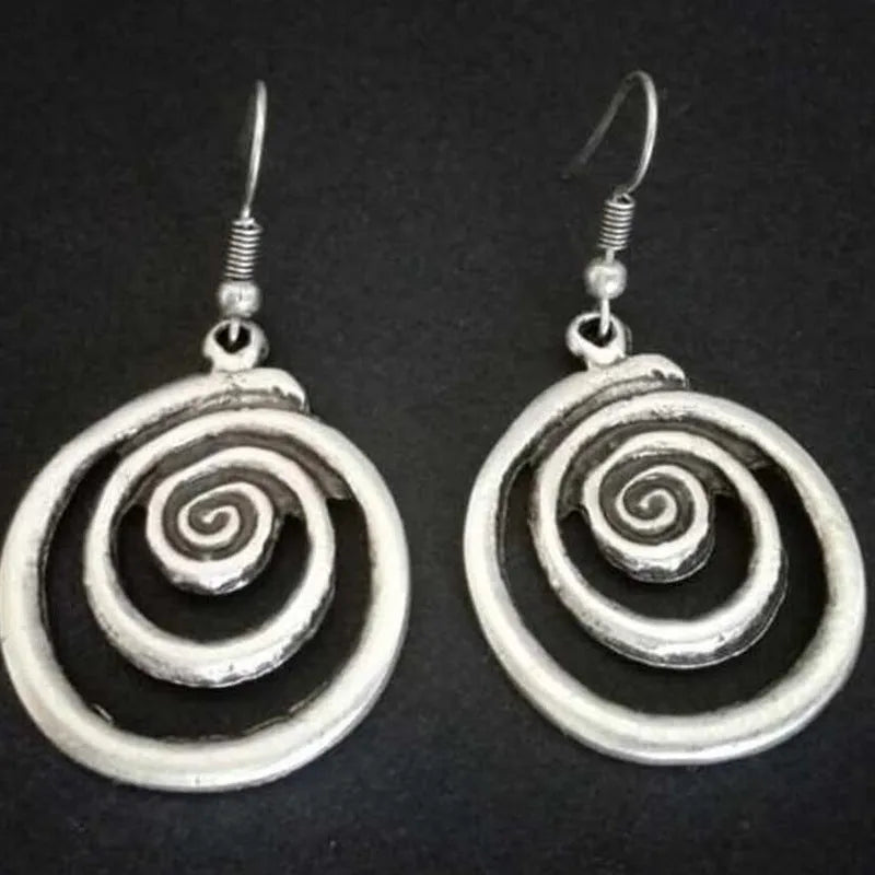 Silver geometric spiral earrings with distressed texture, measuring 2.6cm by 5cm