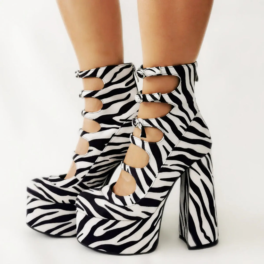 Women's black patent leather platform high heels with a thick serpentine belt and buckle closure.