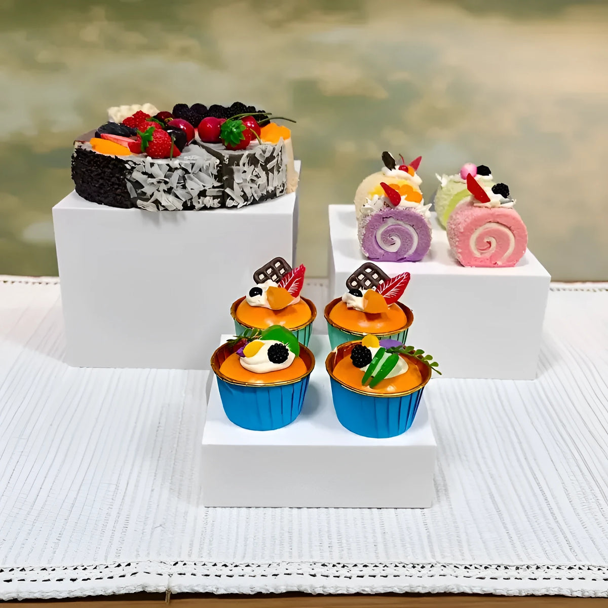 White plastic suit cube dessert display stand with six individual cubes for wedding cakes and pastries.