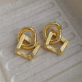 Retro style geometric circle pendant earrings in gold or silver colour with a 3.4cm drop length.
