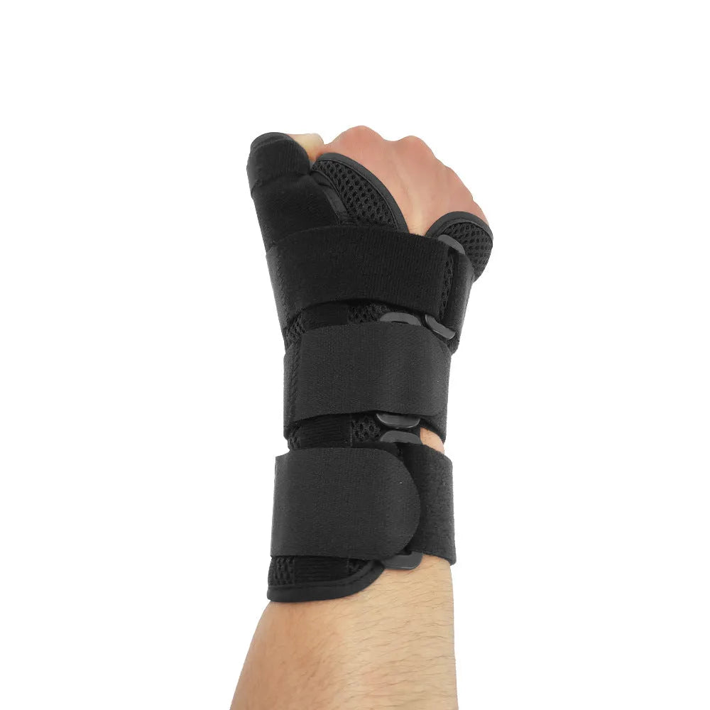 Black and grey carbon fibre sports wrist guard with thumb strap shown on a hand.