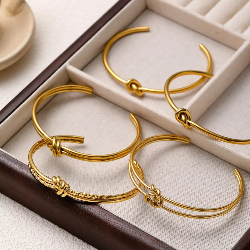 Women's adjustable stainless steel bracelet with knotted C-shaped design and 18K gold plating