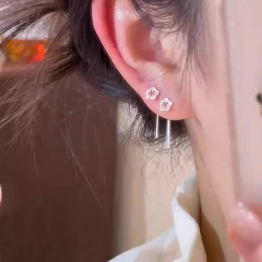 Sterling silver colour hollow flower hanging earrings with petal design