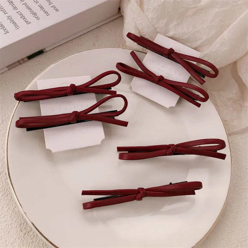 Wine red leather bow barrette hair clip with adjustable metal grip mechanism