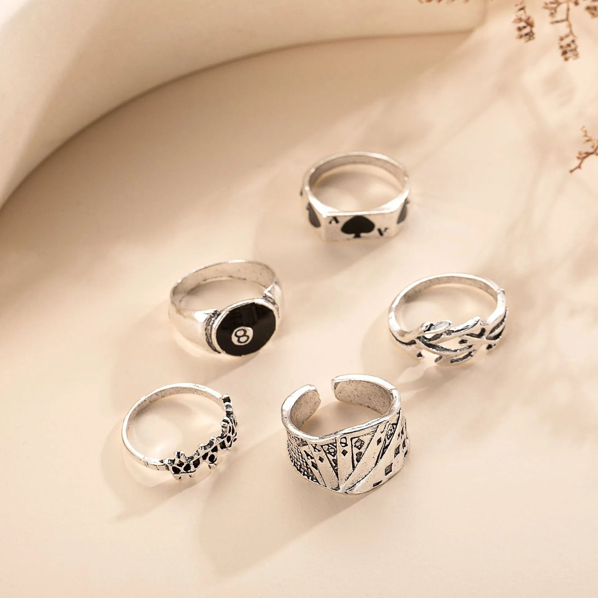 Black alloy adjustable ring with a raised retro spade playing card design on a model's hand.