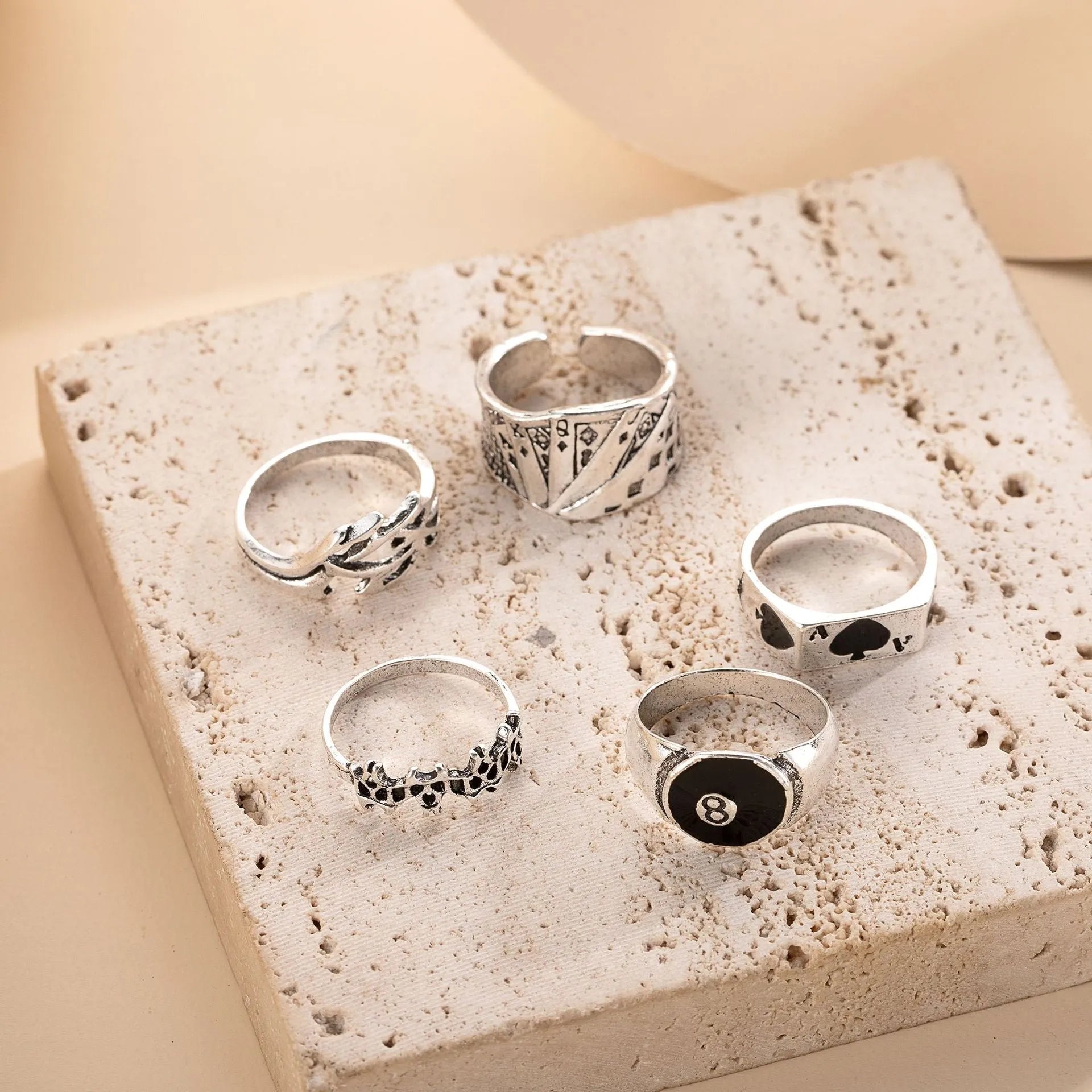 Black alloy adjustable ring with a raised retro spade playing card design on a model's hand.