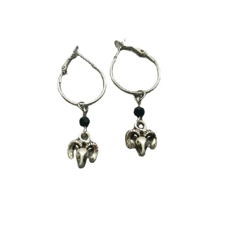 Silver-coloured alloy round earrings with a raised Tibetan antelope design.
